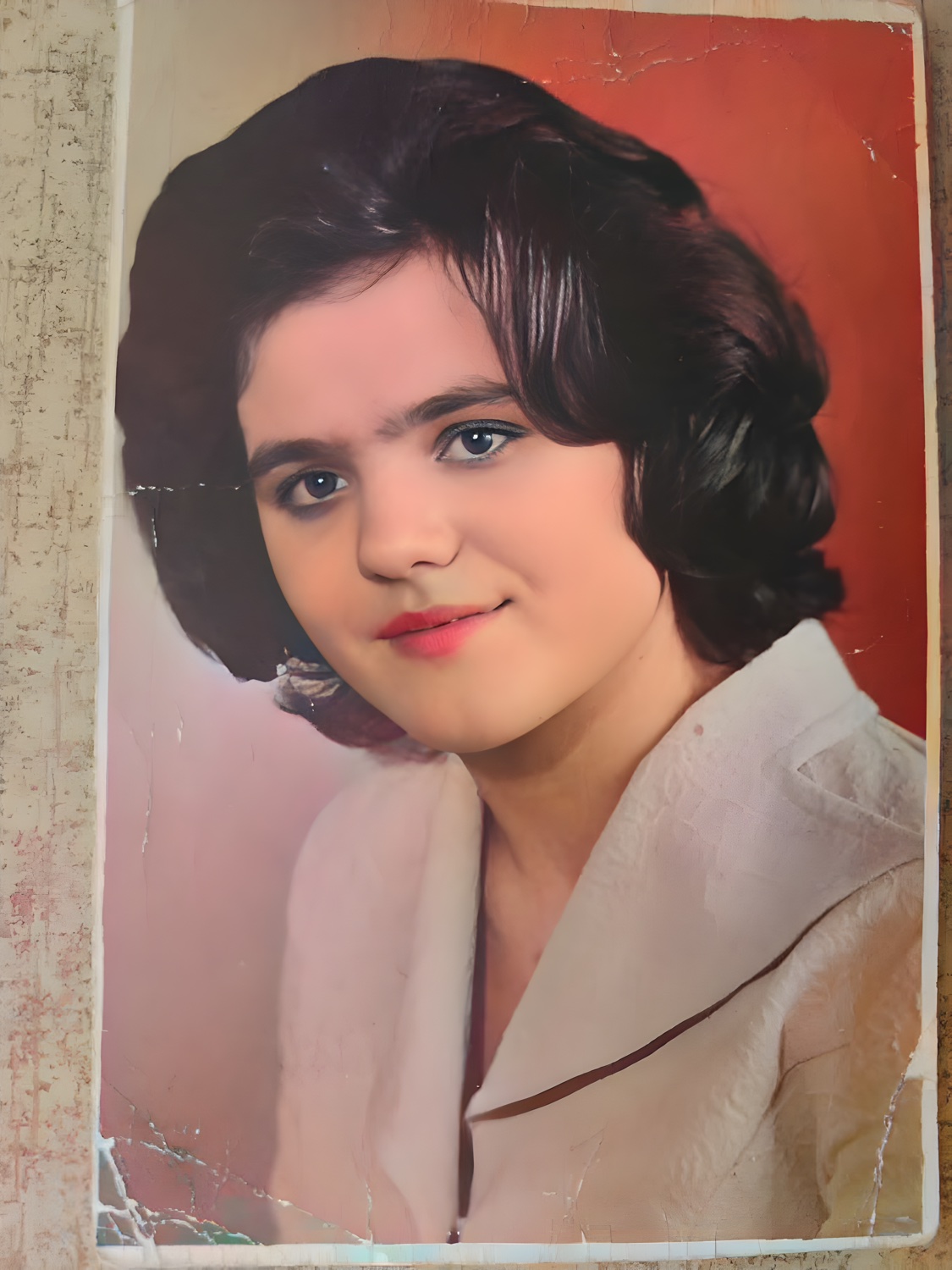 The same 1977 portrait restored and colorized with AI — natural skin tones, the real face preserved