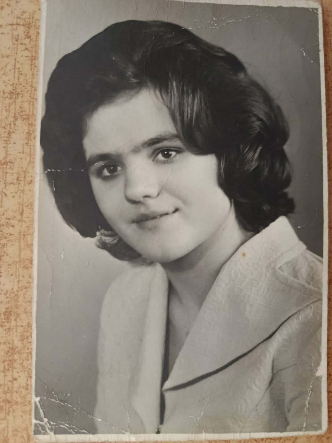 Original 1977 black-and-white school portrait, folded and creased before restoration